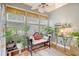 Bright sunroom featuring a charming bench, abundant plants, and natural light from multiple windows at 9316 Sweetbay Ct, Ladson, SC 29456