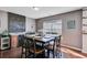 Stylish dining room with dark hardwood floors, a large window, and seating for six at 1005 Golden Aspen Dr, Moncks Corner, SC 29461