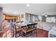 Open dining area flows seamlessly into living room, featuring hardwood floors and a modern aesthetic at 1005 Golden Aspen Dr, Moncks Corner, SC 29461