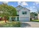 Inviting two-story home featuring a spacious porch with rocking chairs and well-maintained landscaping at 1005 Golden Aspen Dr, Moncks Corner, SC 29461