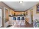 Kitchen bar area with seating featuring dark wood floors and light-colored cabinetry and countertops at 1005 Golden Aspen Dr, Moncks Corner, SC 29461