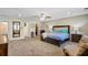 Expansive main bedroom with a sitting area, walk-in closet, and a king-size bed with stylish headboard at 1005 Golden Aspen Dr, Moncks Corner, SC 29461