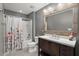 Bathroom features vanity with framed mirror and tub shower with a decorative shower curtain at 1019 Victoria Pointe Ln, Summerville, SC 29485