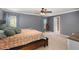 Bedroom suite featuring a large bed, grey walls, two windows, and a connecting bathroom at 1019 Victoria Pointe Ln, Summerville, SC 29485