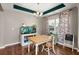Charming dining room with hardwood floors, a unique light fixture, and an aquarium at 1019 Victoria Pointe Ln, Summerville, SC 29485