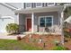 Cozy front porch area with a small table and chairs, complemented by lovely garden decor at 1019 Victoria Pointe Ln, Summerville, SC 29485