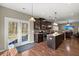 Well-equipped kitchen with dark wood cabinetry, island, pendant lighting and door to backyard at 1019 Victoria Pointe Ln, Summerville, SC 29485