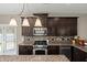 Gourmet kitchen with dark cabinetry, stainless appliances, and mosaic backsplash at 1019 Victoria Pointe Ln, Summerville, SC 29485