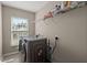 Well-lit laundry room with front-load washer and dryer, and shelving for storage at 1019 Victoria Pointe Ln, Summerville, SC 29485