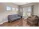 Bright living room with hardwood floors, large windows, and a comfortable seating arrangement at 1019 Victoria Pointe Ln, Summerville, SC 29485