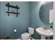 Stylish powder room with vessel sink, industrial shelving, and teal walls at 1019 Victoria Pointe Ln, Summerville, SC 29485