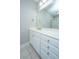 Bathroom vanity with white cabinetry, granite countertops, and a large mirror, creating a bright and functional space at 1025 Riverland Woods Pl # 901, Charleston, SC 29412