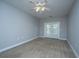 Spacious bedroom with plush carpet, ceiling fan, and access to a balcony, perfect for relaxing at 1025 Riverland Woods Pl # 901, Charleston, SC 29412