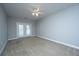 Bright bedroom featuring neutral carpet, ceiling fan, and access to outdoor space through glass paneled doors at 1025 Riverland Woods Pl # 901, Charleston, SC 29412