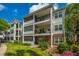 Charming multi-level condo with screened porches, brick accents, and lush landscaping on a sunny day at 1025 Riverland Woods Pl # 901, Charleston, SC 29412