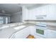 Bright kitchen featuring white cabinetry, modern appliances, and an open layout into living room at 1025 Riverland Woods Pl # 901, Charleston, SC 29412