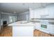 Well-designed kitchen featuring white cabinets, modern appliances, and breakfast bar overlooking living area at 1025 Riverland Woods Pl # 901, Charleston, SC 29412