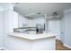 Modern kitchen with white cabinetry, stainless steel appliances, and breakfast bar next to a door at 1025 Riverland Woods Pl # 901, Charleston, SC 29412