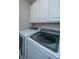 Updated laundry room with modern white cabinets and front load washer and dryer appliances at 1025 Riverland Woods Pl # 901, Charleston, SC 29412