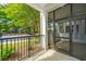 Screened-in patio with a black metal railing overlooking a yard with green trees and adjacent parking lot at 1025 Riverland Woods Pl # 901, Charleston, SC 29412