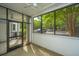 Enclosed patio with ceiling fans with a beautiful view of the parking lot and lush green trees at 1025 Riverland Woods Pl # 901, Charleston, SC 29412