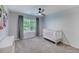 Comfortable bedroom with a crib, window view, soft carpet and bright, neutral walls at 1027 Island View Ct, Charleston, SC 29492