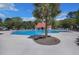 Resort-style community pool featuring mature trees, a palm, and a covered lounging area with a red roof at 1027 Island View Ct, Charleston, SC 29492