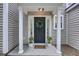 Charming home exterior showcasing a covered front porch, stylish front door, and manicured landscaping at 1027 Island View Ct, Charleston, SC 29492
