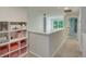 Bright upper hallway with natural light, shelving, and easy access to other rooms at 1027 Island View Ct, Charleston, SC 29492