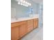Bathroom showcasing wood cabinets, a large mirror, and combined shower-tub at 108 Gaslight Blvd, Summerville, SC 29483