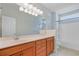 Bathroom showcasing wood cabinets, a large mirror, and combined shower-tub at 108 Gaslight Blvd, Summerville, SC 29483