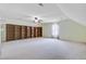Spacious bonus room features built-in shelving, a ceiling fan and neutral-toned walls at 108 Gaslight Blvd, Summerville, SC 29483