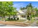Charming home featuring a lush lawn, mature trees, and inviting front porch at 108 Gaslight Blvd, Summerville, SC 29483