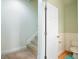 Hallway with carpeted stairs leads to a downstairs powder room at 108 Gaslight Blvd, Summerville, SC 29483
