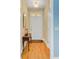 Hallway with hardwood floors, a decorative table, and a front door with transom window at 108 Gaslight Blvd, Summerville, SC 29483