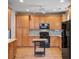 Kitchen featuring sleek black appliances, wood cabinets, and modern countertops at 108 Gaslight Blvd, Summerville, SC 29483