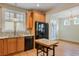 Well-lit kitchen area featuring black appliances and adjacent dining space at 108 Gaslight Blvd, Summerville, SC 29483