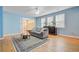 Well-lit living room with hardwood floors, a ceiling fan, and a comfortable sofa at 108 Gaslight Blvd, Summerville, SC 29483