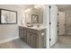 This spacious bathroom features double sinks, gray cabinetry, and a large mirror at 108 O'Leary Cir, Summerville, SC 29483
