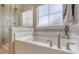 A luxurious bathroom features a soaking tub, a glass-enclosed shower, and stylish tile work at 108 O'Leary Cir, Summerville, SC 29483