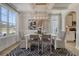 This dining room offers coffered ceilings, large windows, modern chandelier, and stylish decor at 108 O'Leary Cir, Summerville, SC 29483
