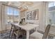 This dining room features natural light from large windows and modern décor at 108 O'Leary Cir, Summerville, SC 29483