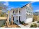 Beautiful two-story home features a side porch, two-car garage, and manicured landscaping, all beneath a clear blue sky at 108 O'Leary Cir, Summerville, SC 29483