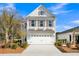 Charming two-story white home with a well-manicured lawn and an attached two-car garage on a sunny day at 108 O'Leary Cir, Summerville, SC 29483