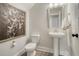 A charming powder room includes a pedestal sink, modern art and fixtures at 108 O'Leary Cir, Summerville, SC 29483