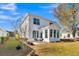 This home features a rear exterior view with a patio and a beautiful landscaped yard on a sunny day at 108 O'Leary Cir, Summerville, SC 29483