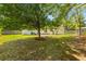 Large backyard with mature trees offering ample shade and privacy, perfect for outdoor enjoyment at 111 Driver Ave, Summerville, SC 29483