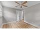 A bright bedroom with neutral paint, wood floors, trim, a ceiling fan, and an entry door at 111 Driver Ave, Summerville, SC 29483