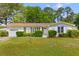 Charming brick home with attached garage and lush landscaping on a sunny day at 111 Driver Ave, Summerville, SC 29483