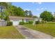 Inviting one-story brick home with lush front yard, trimmed hedges, and an attached garage at 111 Driver Ave, Summerville, SC 29483